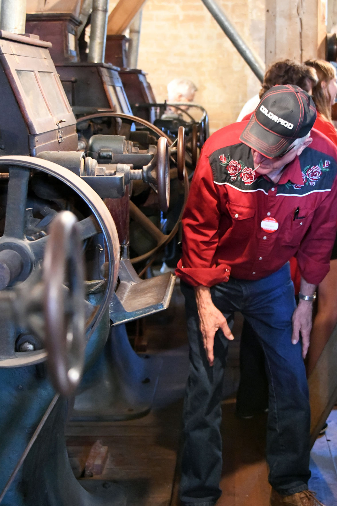 008 Don Rut examines the old equipment at the flour mill.JPG